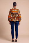 Haut wax africain Oumou portefeuille motif graphique brun et orange manches bouffantes