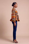 Haut wax africain Oumou portefeuille motif graphique brun et orange manches bouffantes